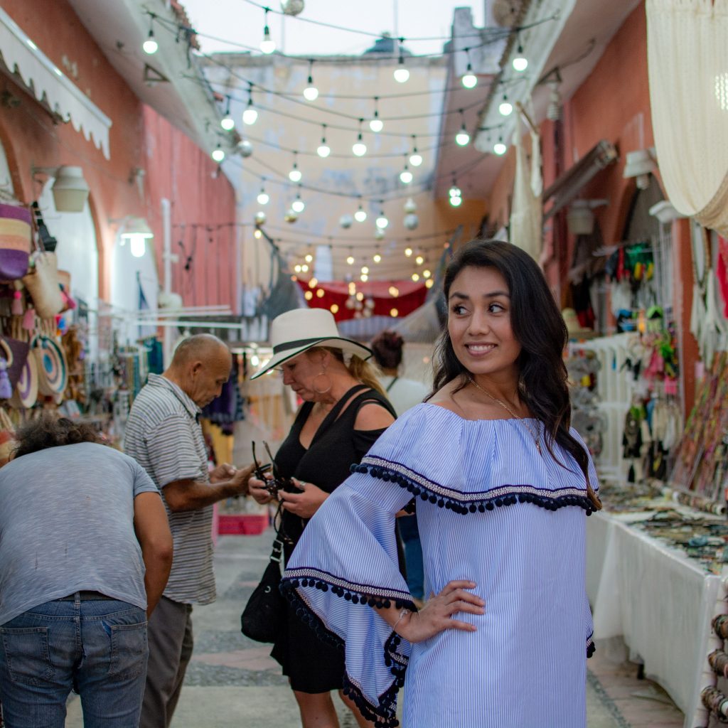 Tourist poses for an Instagram photo in a shop in Playa del Carmen Mexico