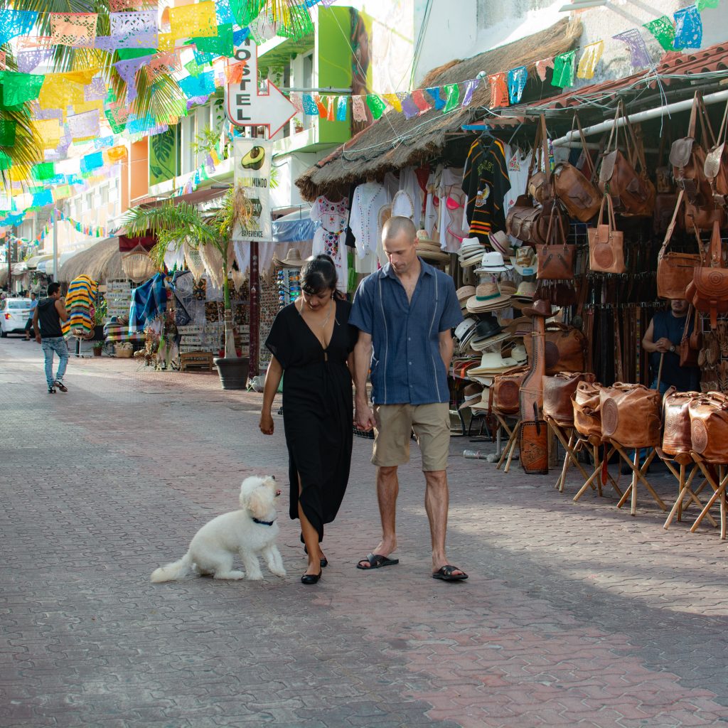 tourist couple walking down the main street of Playa del Carmen Mexico