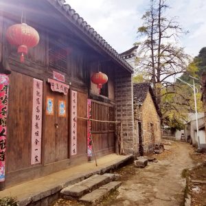 Chinese oil tea shop with red lanterns and wood exterior