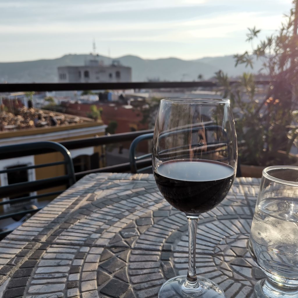 A glass of red wine on a rooftop terrace in Oaxaca Mexico
