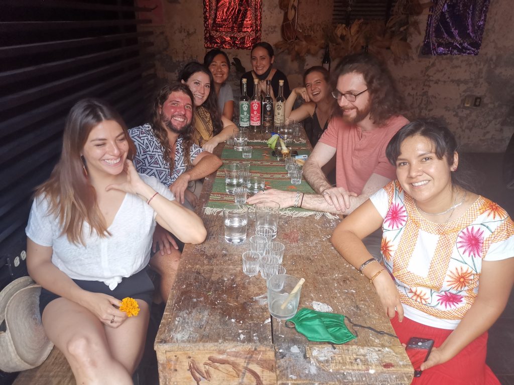 Solo travelers making new friends at a mezcal tasting in Oaxaca Mexico