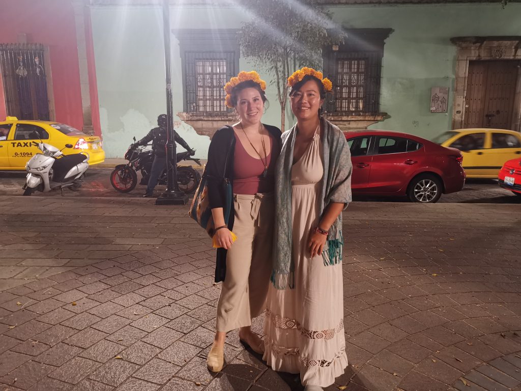 Two solo female travelers celebrating Dia de los Muertos or Day of the Dead in Oaxaca Mexico